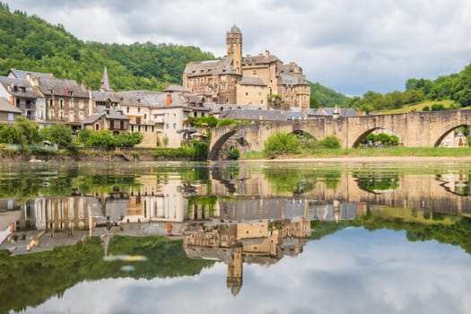 Estaing village, castle and medieval bridge over Lot river photographed in Aveyron, one of the most beautiful villages of France