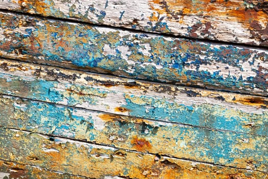 Peeling weathered hull paint, background texture with harsh shaddows