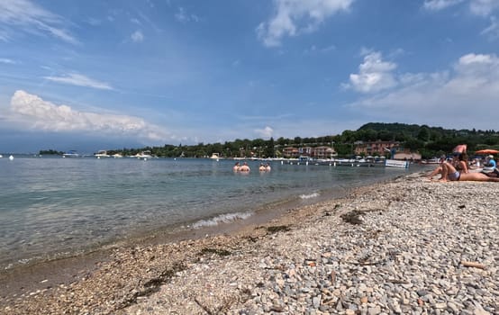 Tourists on the beach of Manerba del Garada on Lake Garda,in the neighboring town of Torri del Benaco,there was a large outbreak with the norovirus  Travel Photography - Lake Garda / Lago di Garda / Italy / Italy / Italia
