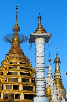 Temples in the Shwedagon Pagoda complex in the city of Yangon in Myanmar (Burma). The Shwedagon Pagoda, officially titled Shwedagon Zedi Daw, is a 99m (325ft) gilded pagoda and stupa. The complex contains hundreds of other Buddhist stupa, temples and shrines.