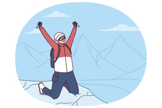 Inspired traveler man stands on mountaintop rejoicing at successful climbing Everest peak or new world record. Male tourist raises hands as sign of victory after climbing on hard to reach place