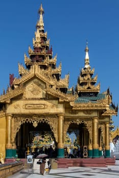 Temples in the Shwedagon Pagoda complex in the city of Yangon in Myanmar (Burma). The Shwedagon Pagoda, officially titled Shwedagon Zedi Daw, is a 99m (325ft) gilded pagoda and stupa. The complex contains hundreds of other Buddhist stupa, temples and shrines.