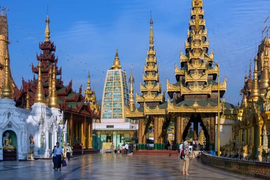 Temples in the Shwedagon Pagoda complex in the city of Yangon in Myanmar (Burma). The Shwedagon Pagoda, officially titled Shwedagon Zedi Daw, is a 99m (325ft) gilded pagoda and stupa. The complex contains hundreds of other Buddhist stupa, temples and shrines.