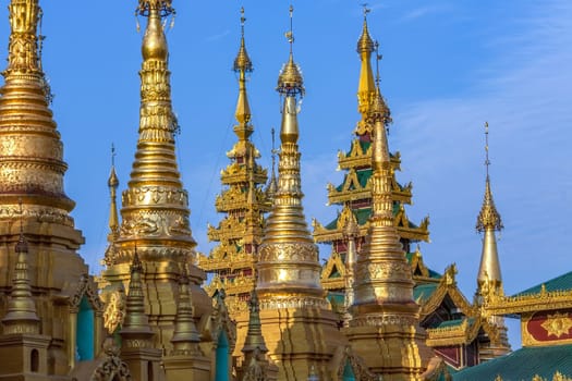Temples in the Shwedagon Pagoda complex in the city of Yangon in Myanmar (Burma). The Shwedagon Pagoda, officially titled Shwedagon Zedi Daw, is a 99m (325ft) gilded pagoda and stupa. The complex contains hundreds of other Buddhist stupa, temples and shrines.