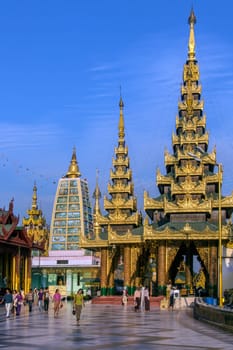 Temples in the Shwedagon Pagoda complex in the city of Yangon in Myanmar (Burma). The Shwedagon Pagoda, officially titled Shwedagon Zedi Daw, is a 99m (325ft) gilded pagoda and stupa. The complex contains hundreds of other Buddhist stupa, temples and shrines.