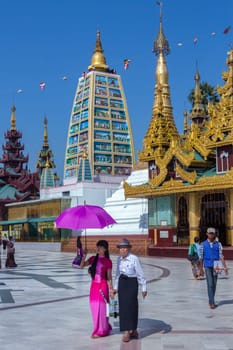 Temples in the Shwedagon Pagoda complex in the city of Yangon in Myanmar (Burma). The Shwedagon Pagoda, officially titled Shwedagon Zedi Daw, is a 99m (325ft) gilded pagoda and stupa. The complex contains hundreds of other Buddhist stupa, temples and shrines.