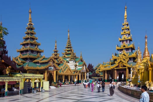 Temples in the Shwedagon Pagoda complex in the city of Yangon in Myanmar (Burma). The Shwedagon Pagoda, officially titled Shwedagon Zedi Daw, is a 99m (325ft) gilded pagoda and stupa. The complex contains hundreds of other Buddhist stupa, temples and shrines.