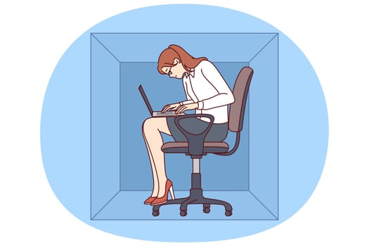 Woman with laptop sits in cardboard box typing article working in cramped office of small company. Young girl office worker is inconvenienced due to lack of free space in workplace