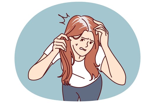 Worried woman with gray hair is nervous due to premature baldness associated with lack of nutrients and calcium. Girl needs trip to dermatologist due to appearance of gray hair or dandruff