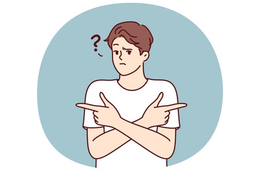 Puzzled man pointing fingers in different directions doubtful trying to accept difficult decision with unknown consequences. Puzzled guy is wondering what to make choice between two options