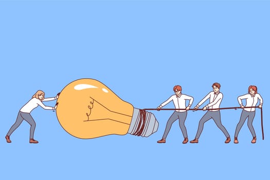 Teamwork on idea for business people pulling giant light bulb symbolizing new startup project. Excellent teamwork among office clerks produces good results leading to company growth