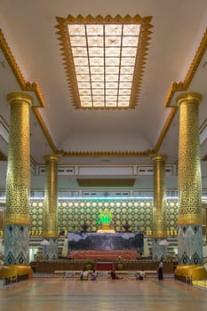 Interior of the Mahapasana Guha Cave and Buddhist Ordination Hall in Yangon, Myanmar. It is adjacent to the Kaba Aye Pagoda. Here, religious examination called the Tipitakadhara Tipitaka Kovida Examinations take place, an extensive recitation, oral and written examination on the Tipitaka, the religious body of works in Theravada Buddhism.
