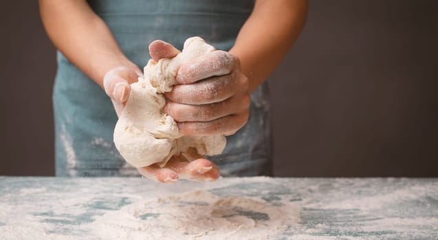 Baker kneading dough for pizza or artisan bread with his hands, prepare ingredients for food, baking pastry