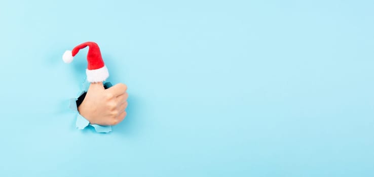Thumb up, Santa Claus hat, Christmas holiday, positive hand gesture, optimism and emotion, winter season