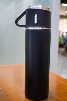 Thermos for preservation of a hot or cold drink water bottle, stock photo