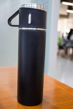 Thermos for preservation of a hot or cold drink water bottle, stock photo