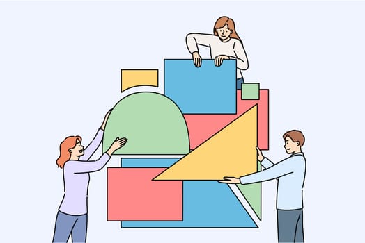 Business people put together puzzle in attempt to build reliable company that brings good profits. Students solve puzzle demonstrating teamwork and synergy increasing chances of success