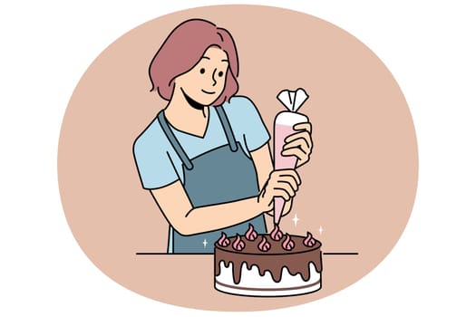 Woman confectioner prepares delicious cake for birthday party and decorates dessert with chocolate and butter cream. Young girl uses pastry bag to prepare sweet cake for festive table.