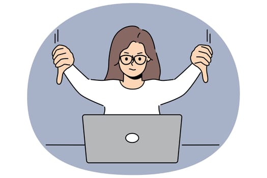 Woman freelancer showing thumbs down sitting in front of laptop and making video call to colleagues while discussing future project. Girl demonstrate thumbs down as sign of negative user experience