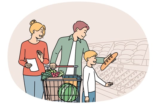 Happy family is shopping in supermarket, standing with trolley near shelves with fresh bread. Boy visits grocery store with parents choosing pastries or bread, for concept of healthy diet