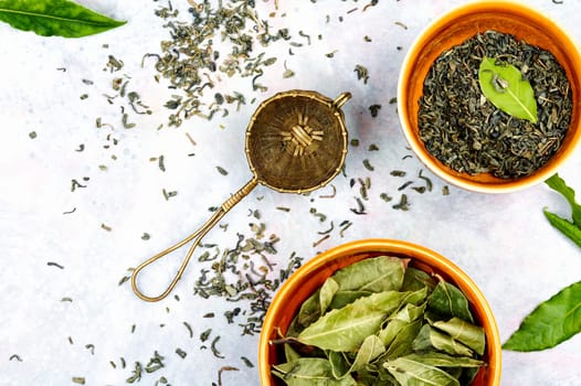 Healthy bay leaf tea and vintage tea sieve. Natural herbal medicine. Aromatic spice. Top view