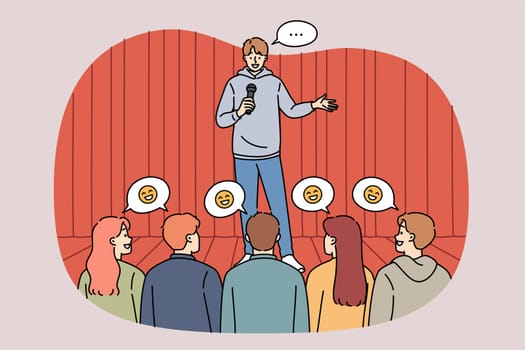 Man stand-up comedian performs in front of audience, telling jokes from stage and making people laugh. Guy works as comedian and cheers up men or women who attended comedy concert.