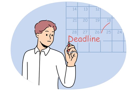Business man fills in calendar and makes note of deadlines so as not to miss day of reporting to customer. Guy works as team leader and keeps track of deadlines for data to complete tasks.
