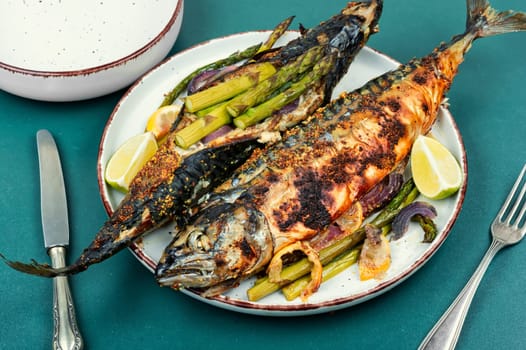 Dietary aromatic mackerel fish barbecue with green asparagus. Flat lay.