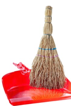 A small household broom for cleaning up waste.