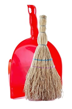 A small household broom for cleaning up waste.