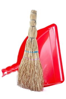 A small household broom for cleaning up waste.