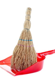 A small household broom for cleaning up waste.