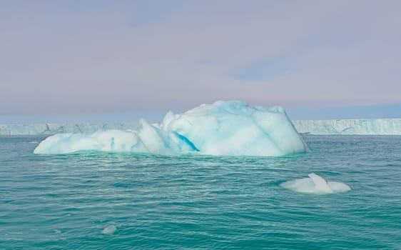 Massive and Coloful Iceberg in Front of a Tidal Glacier on Nordaustlandet Island in the Svalbard islands