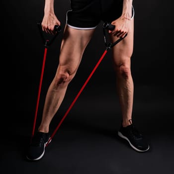 Athletic female performs exercises using resistance band. Strength and motivation