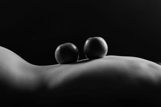 Red apple of Beautiful female body. Seductive booty of a young woman. Naked woman