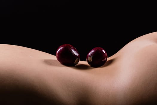 Close up of a woman back with laying onion, low key