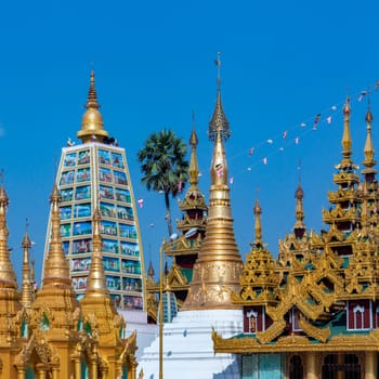 Temples in the Shwedagon Pagoda complex in the city of Yangon in Myanmar (Burma). The Shwedagon Pagoda, officially titled Shwedagon Zedi Daw, is a 99m (325ft) gilded pagoda and stupa. The complex contains hundreds of other Buddhist stupa, temples and shrines.