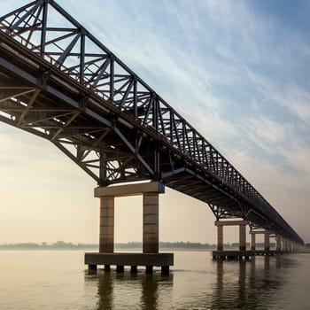 Bridge over the Irrawaddy River (Ayeyarwaddy River) in Myanmar (Burma).  It is the country's largest river and most important commercial waterway. Originating from the confluence of the N'mai and Mali rivers, it flows relatively straight North-South before emptying through the Irrawaddy Delta into the Andaman Sea.