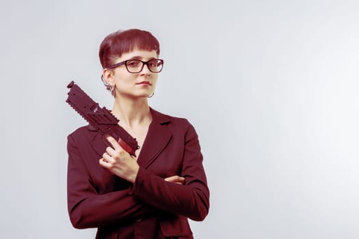 Businesswoman is holding a gun and standing with her arms crossed, representing concepts of power, confidence, and defense in the corporate world