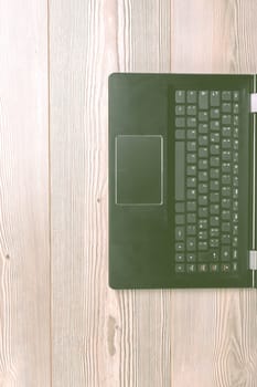 Personal computer is sitting on a desk with a wood grain finish, conveying concepts of business, technology, and communication