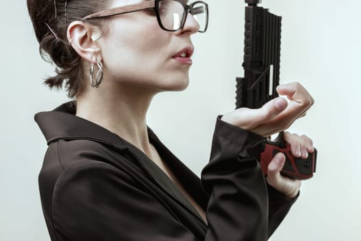 woman, embodying a novel's killer, holds a gun with confidence. Her smug expression and poised demeanor highlight her self-assured belief in being the best and her pride