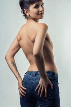 confident woman proudly shows her back and glances over her shoulder, expressing pride in her body and her sexuality. Her pose symbolizes her self-empowerment and ownership of her freedom