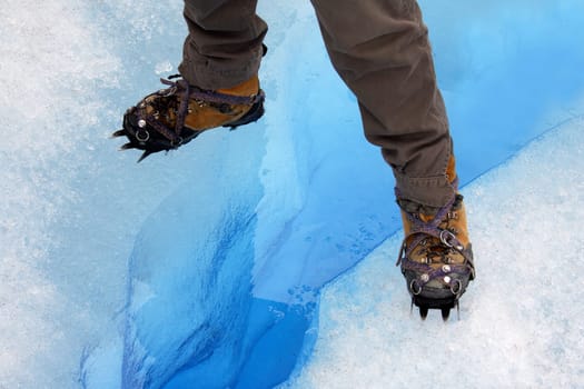 Standing over a crevasse on the Perito Moreno Glacier in Patagonia in southern Argentina, South America.