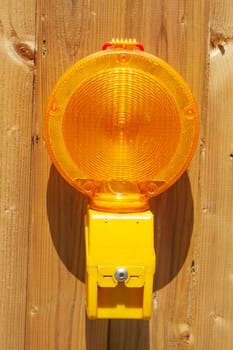 Orange construction site lamp on a site fence, Germany