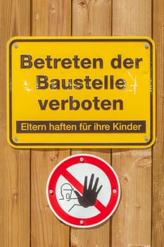Yellow sign No trespassing on a construction site, Germany
