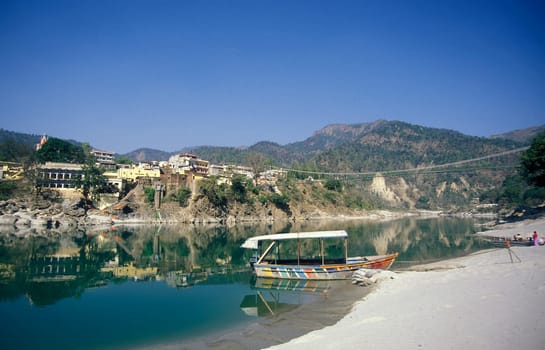 the Holy Ganges River with the city of Rishikesh in the Province Uttarakhand in India.  India, Rishikesh, February, 1998