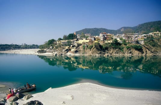 the Holy Ganges River with the city of Rishikesh in the Province Uttarakhand in India.  India, Rishikesh, February, 1998