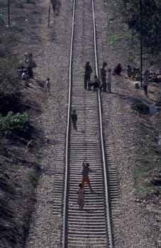 People at a Indian railway line near the city of Haridwar in the Province Uttarakhand in India.  India, Haridwar, February, 1998