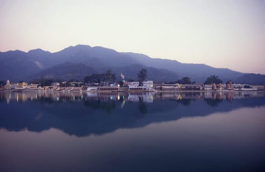 the Holy Ganges River with the city of Rishikesh in the Province Uttarakhand in India.  India, Rishikesh, February, 1998