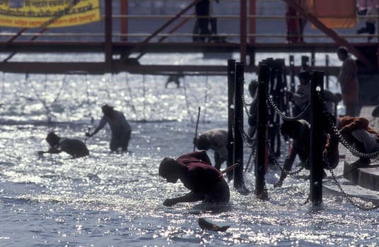a men and treasure hunter search in the Holy Ganges River in the city of Haridwar in the Province Uttarakhand in India.  India, Haridwar, February, 1998